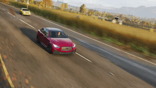 A Red Car Is Driving Down A Country Road GIF