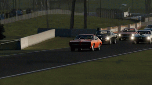 A Red Car Is Driving Down A Race Track GIF