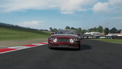 a red car is driving down a race track in a video game