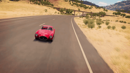 A Red Car Is Driving Down A Road With A Bridge In The Background GIF