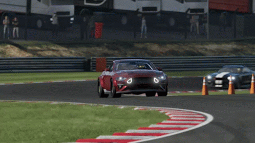 a red car is driving on a race track