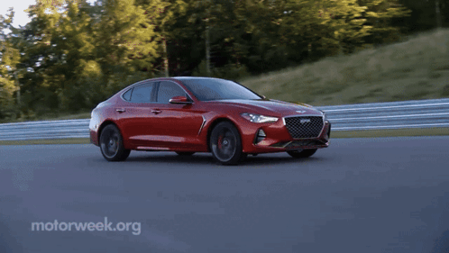 A Red Car Is Driving On A Track With Motorweek.org Written On The Bottom Right GIF