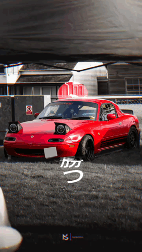 A Red Car Is Parked In A Parking Lot With A Sign That Says No Smoking GIF