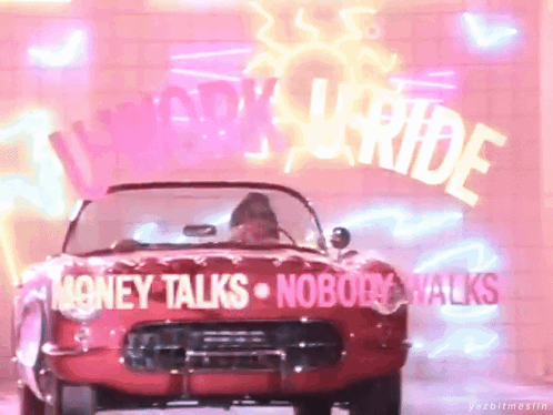 A Red Car Is Parked In Front Of A Neon Sign That Says " Money Talks Nobody Walks " GIF