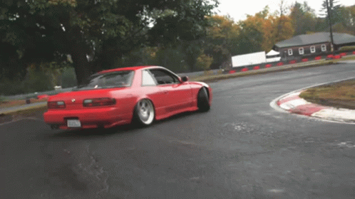 A Red Car On A Track With A License Plate That Says ' Nc ' GIF