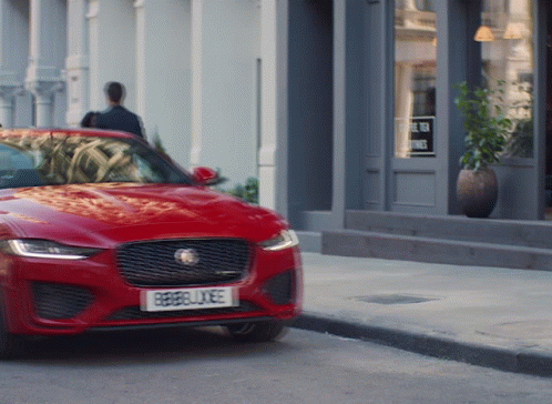 A Red Car With A License Plate That Says Rebellxee GIF