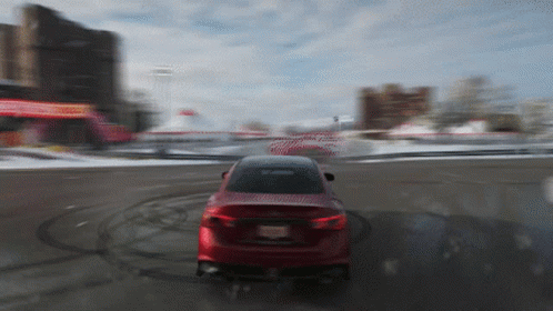 A Red Car With A New Jersey License Plate Is Driving On A Snowy Road GIF