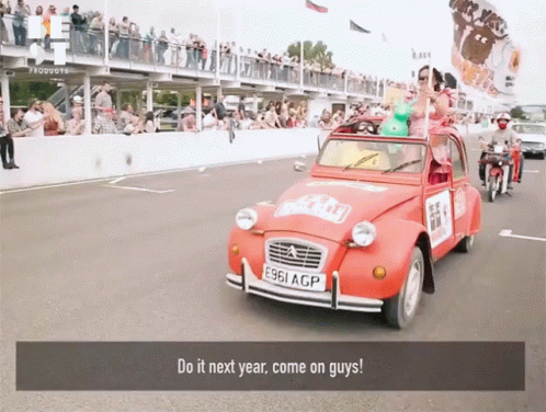 A Red Car With The License Plate E961 Acp Is Driving Down The Road GIF