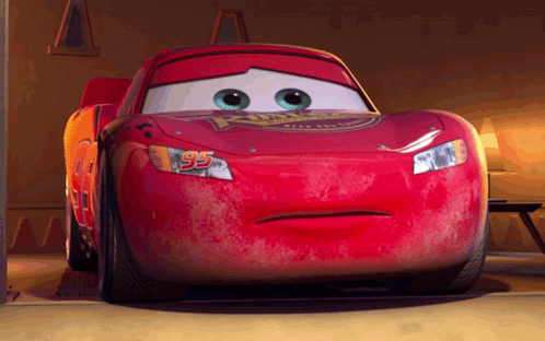 A Red Cartoon Car With The Number 95 On It GIF