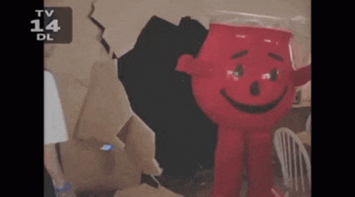 A Red Cartoon Character With A Smile On His Face Is On A Tv Screen GIF