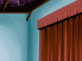 A Red Curtain Is Hanging On A Blue Wall In A Room GIF
