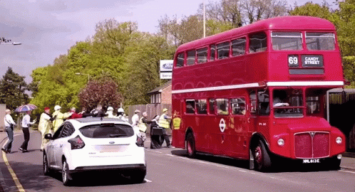 A Red Double Decker Bus With The Number 69 On The Side GIF