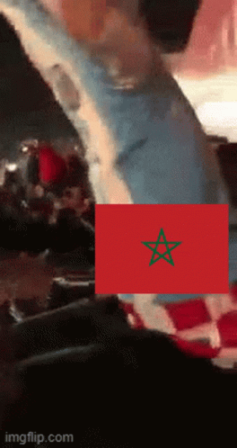 A Red Flag With A Green Star On It Is Being Displayed On A Screen GIF