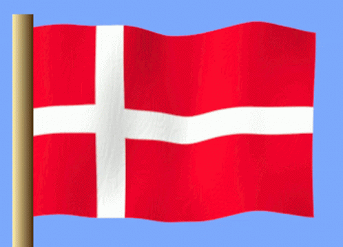 A Red Flag With A White Cross On It Is Waving In The Wind GIF