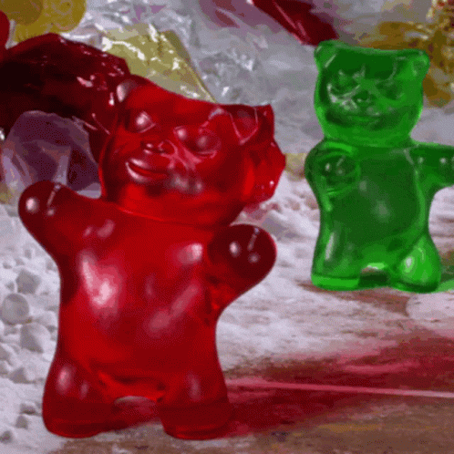 A Red Gummy Bear And A Green Gummy Bear GIF