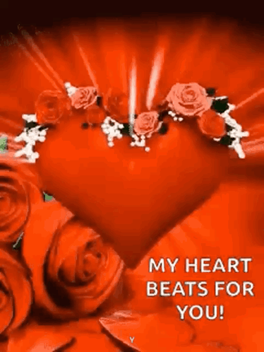 A Red Heart Surrounded By Red Roses With A Message That Says `` My Heart Beats For You '' . GIF