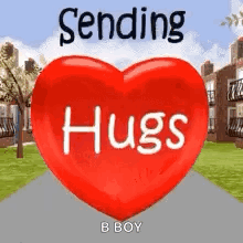 A Red Heart With The Words `` Sending Hugs '' Written On It Is Sitting On A Sidewalk . GIF