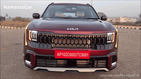 A Red Kia Car With A License Plate That Reads Ap102c003tc0001 GIF
