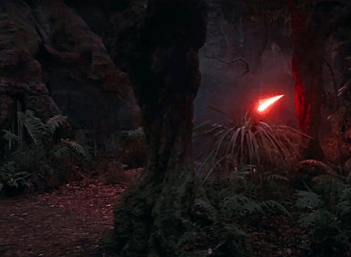 A Red Light Beam Is Coming Out Of A Red Object In The Dark . GIF