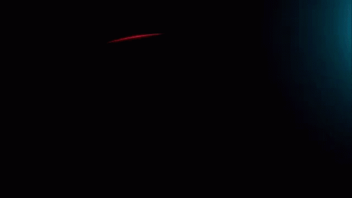A Red Light Is Coming Out Of A Dark Background GIF
