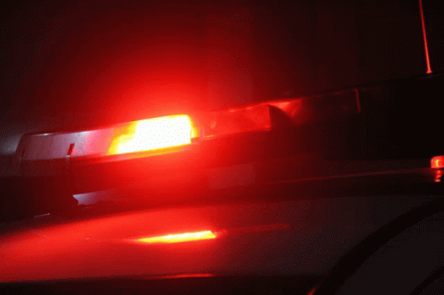 A Red Light Is Lit Up On The Roof Of A Car GIF