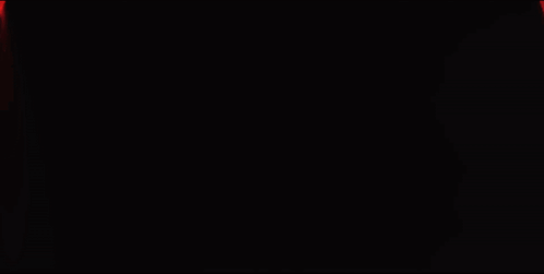 A Red Light Is Shining On A Dark Background GIF