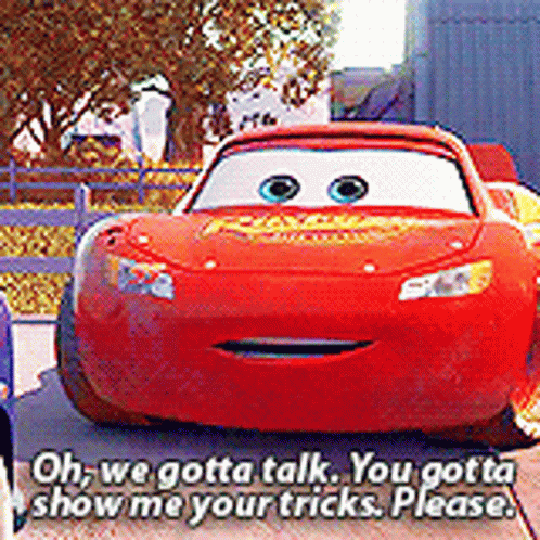 A Red Lightning Mcqueen Car Is Talking To Another Car . GIF