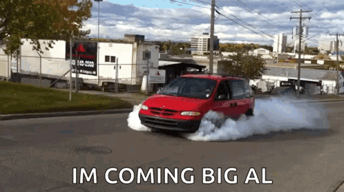 A Red Minivan Is Driving Down A Street With Smoke Coming Out Of It And The Words Im Coming Big Al GIF