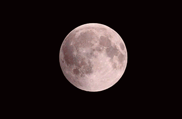 A Red Moon In The Night Sky With A White Crescent GIF