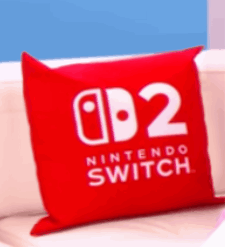 A Red Nintendo Switch Pillow Is On A White Couch GIF