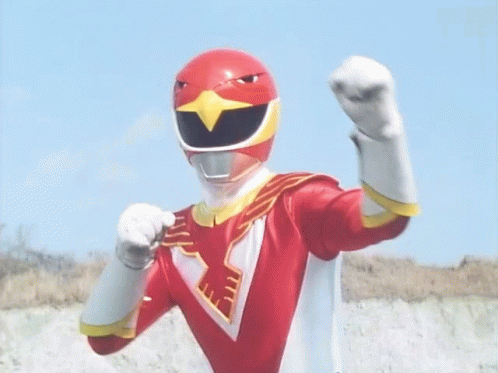 A Red Power Ranger With A Bird On His Helmet Is Standing In Front Of A Blue Sky With His Arms Outstretched . GIF