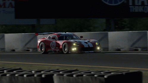 A Red Race Car With The Number 83 On It GIF