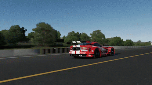 A Red Race Car With The Word Castrol On The Side Is Driving Down A Road GIF