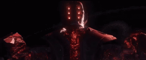 A Red Robot With A Glowing Head Is Standing In The Dark GIF