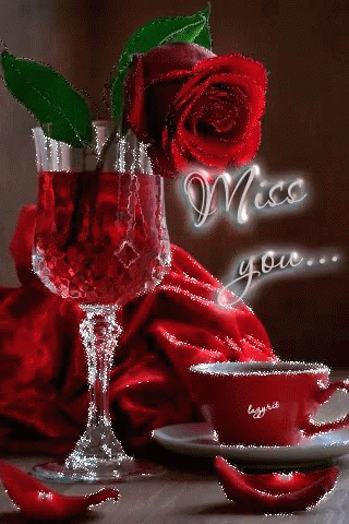 A Red Rose Is Sitting Next To A Glass Of Red Wine And A Cup Of Coffee . GIF
