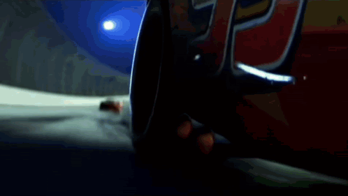 A Red Rusteze Race Car Is Driving Down A Track GIF