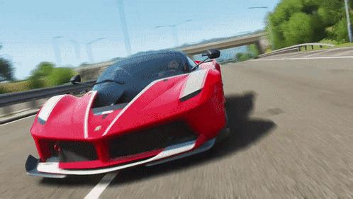 A Red Sports Car Is Driving Down The Road GIF