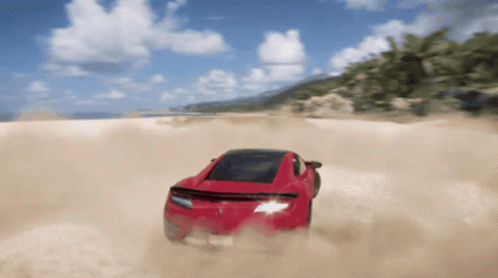 A Red Sports Car Is Driving Through A Sandy Desert GIF