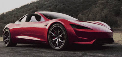 A Red Sports Car Is Parked On The Road GIF
