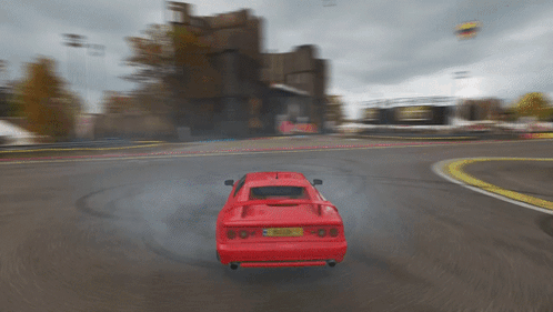 A Red Sports Car With A License Plate That Says ' A ' On It Is Driving Down A Road GIF