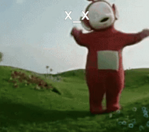 A Red Teletubbies Character Is Standing In A Grassy Field GIF