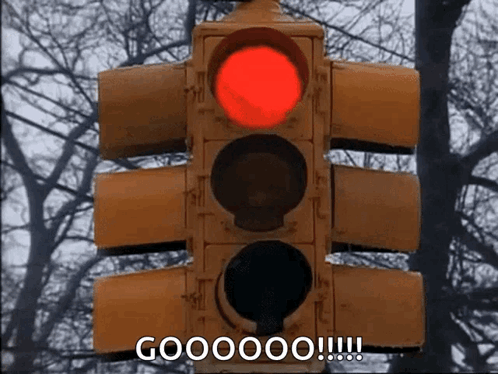 A Red Traffic Light With The Words Goooooo !!! Below It GIF