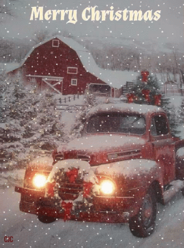 A Red Truck With A Christmas Tree On Top Of It And The Words Merry Christmas Above It GIF