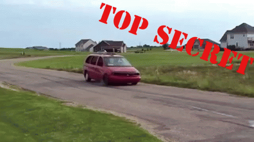 A Red Van Is Driving Down A Road With Top Secret Written On The Bottom GIF