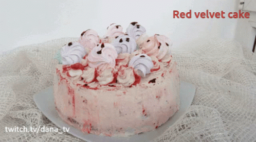 A Red Velvet Cake Is Sitting On A Table GIF