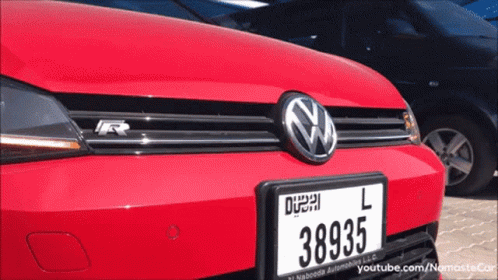 A Red Volkswagen With A License Plate That Says 38935 On It GIF