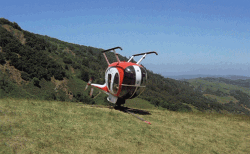 A Red White And Black Helicopter With The Number 10 On The Side GIF