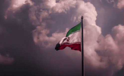 A Red White And Green Flag Is Flying In The Wind GIF