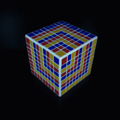 A Red Yellow And Blue Rubik 'S Cube On A Dark Background GIF