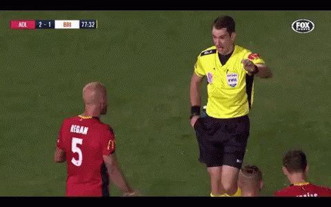 A Referee Gives A Yellow Card To A Player With The Number 5 GIF